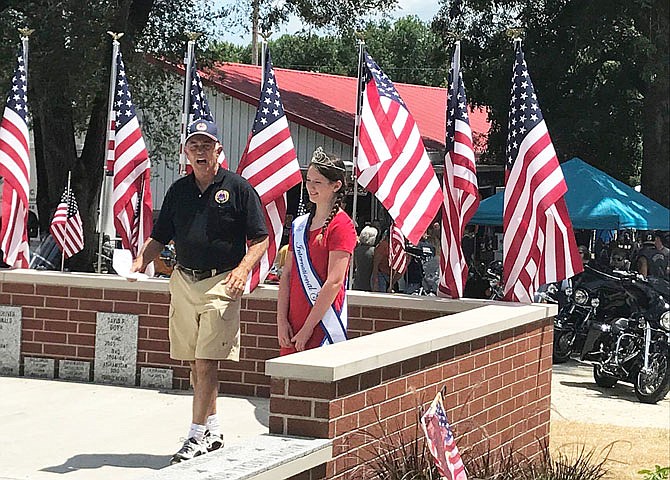 Don Dettmann of the AMVETS Post 153 and Katie Bernicky, 12, the 2017 Missouri Young Miss crown holder, dedicate a memorial wall Saturday. Bernicky has single-handedly raised enough money to send 19 veterans to Washington, D.C., via the Central Missouri Honor Flight program.