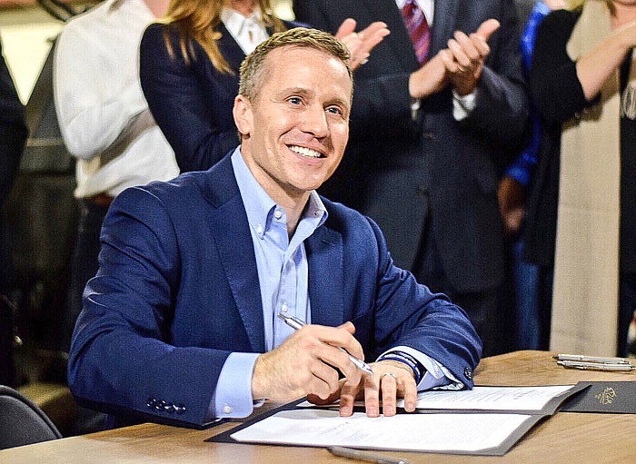 In this photo provided by his office, Missouri Gov. Eric Greitens signs right-to-work legislation Feb. 6, 2017.
