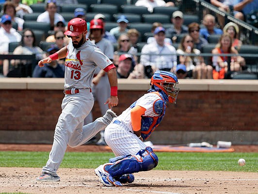 Cardinals infielder Matt Carpenter scores past Mets catcher Rene Rivera during Thursday's game in New York.