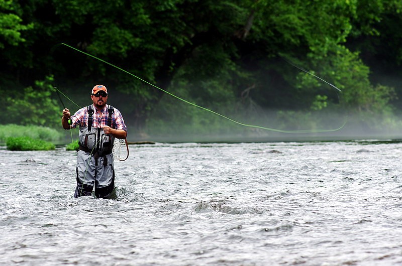 The North Fork of the White River arguably offers Missouri's best trout fishing, proclaims Brandon Butler, seen above as he casts into the river.