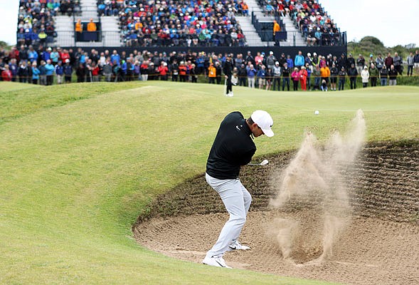 Brooks Koepka plays out of a bunker on the seventh hole Friday during the first round of the British Open at Royal Birkdale in Southport, England.