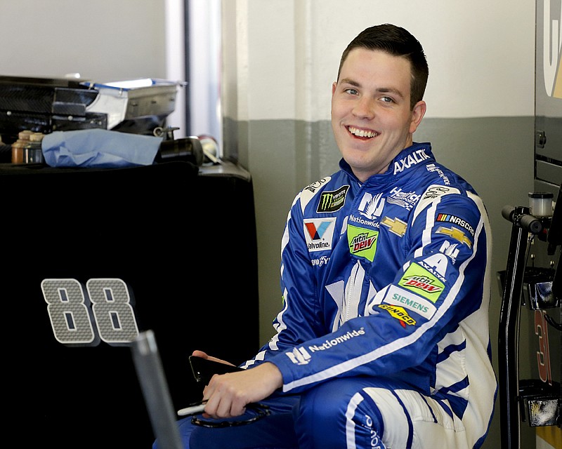 Alex Bowman smiles to team members in his garage during a practice session for a NASCAR auto race Feb. 17 at Daytona International Speedway in Daytona Beach, Fla. Dale Earnhardt Jr. got the replacement he wanted. Bowman got his dream job. Hendrick Motorsports announced Thursday that the 24-year-old Bowman will replace one of the series' biggest stars in the No. 88 car next season after Earnhardt retires.