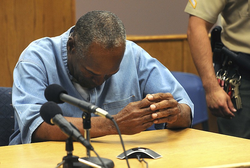 Former NFL football star O.J. Simpson reacts after learning he was granted parole Thursday at Lovelock Correctional Center in Lovelock, Nev. Simpson was convicted in 2008 of enlisting some men he barely knew, including two who had guns, to retrieve from two sports collectibles sellers some items that Simpson said were stolen from him a decade earlier. 