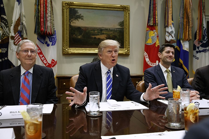 FILE - In this March 1, 2017 file photo, President Donald Trump, flanked by Senate Majority Leader Mitch McConnell of Ky., left, and House Speaker Paul Ryan of Wis., speaks during a meeting with House and Senate leadership, in the Roosevelt Room of the White House in Washington. Repeal and replace “Obamacare.” Just repeal. Or let it fail _ maybe with a little nudge. President Donald Trump has sent a flurry of mixed messages, raising questions about the White House strategy on health care.  (AP Photo/Evan Vucci, File)