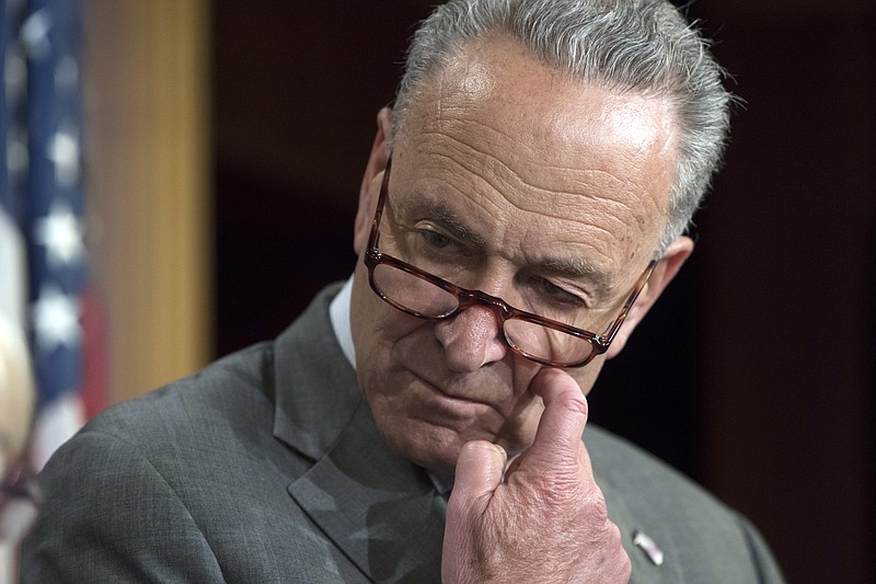 In this July 13, 2017 photo, Senate Minority Leader Chuck Schumer of N.Y. pauses during a news conference on Capitol Hill in Washington.  Congressional Democrats announced Saturday that a bipartisan group of House and Senate negotiators have reached an agreement on a sweeping Russia sanctions package to punish Moscow for meddling in the presidential election and its military aggression in Ukraine and Syria.  Schumer called the sanctions legislation "strong" and he expected the legislation to be passed promptly.  (AP Photo/J. Scott Applewhite)