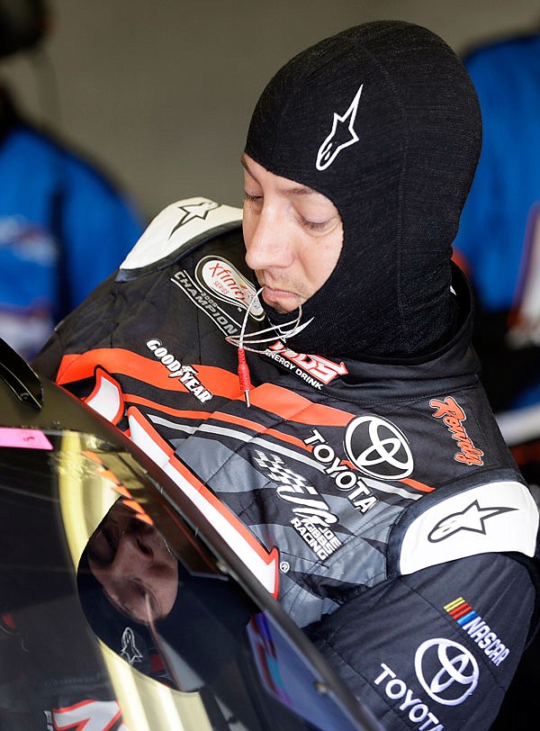 Kyle Busch climbs into his car Friday during practice for the NASCAR Xfinity series race at Indianapolis Motor Speedway.