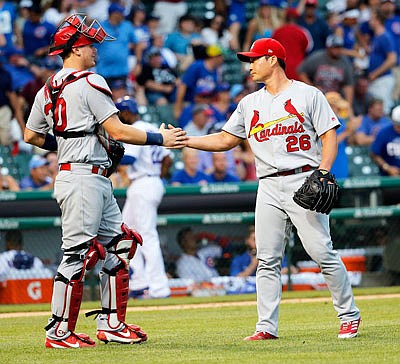 Cardinals catcher Carson Kelly celebrates with Seung-Hwan Oh on Friday after the Cardinals' 11-4 win against the Cubs in Chicago.