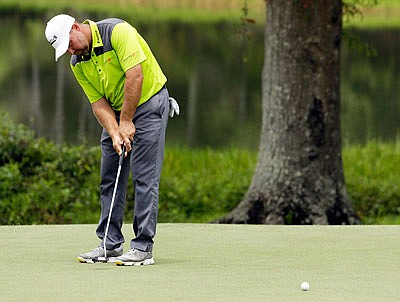 Chad Collins putts on the 17th hole Friday during the Barbasol Championship at Grand National Golf Course in Opelika, Ala.