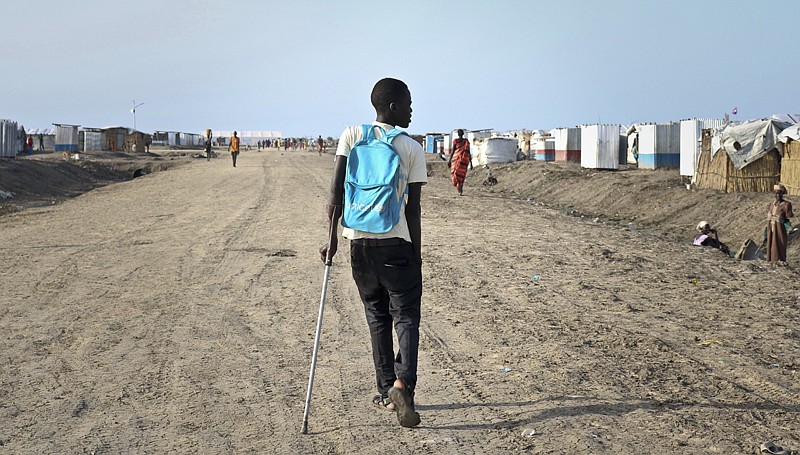 Former child soldier James walks down the road from his small hut to his first day at his new school on May 29 in Bentiu, South Sudan. James was recently reunited with his mother, who had thought he was dead. One of an estimated 18,000 children fighting in South Sudan according to the United Nations, he was left for dead on a battlefield, while back home his mother mourned him and held a funeral without a body, having no idea he was still alive.