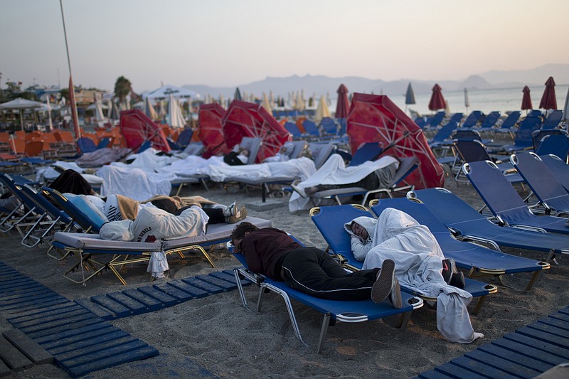 Tourist sleep on sun beds at a beach of the Greek island of Kos, on Saturday, July 22, 2017. Hundreds of residents and tourists on the eastern Greek island of Kos spent the night sleeping outdoors, on beach lounge-chairs, in parks and olive groves or in their cars, a night after a powerful earthquake killed two tourists and injured nearly 500 others across the Aegean Sea region, in Greece and Turkey. (AP Photo/Petros Giannakouris)