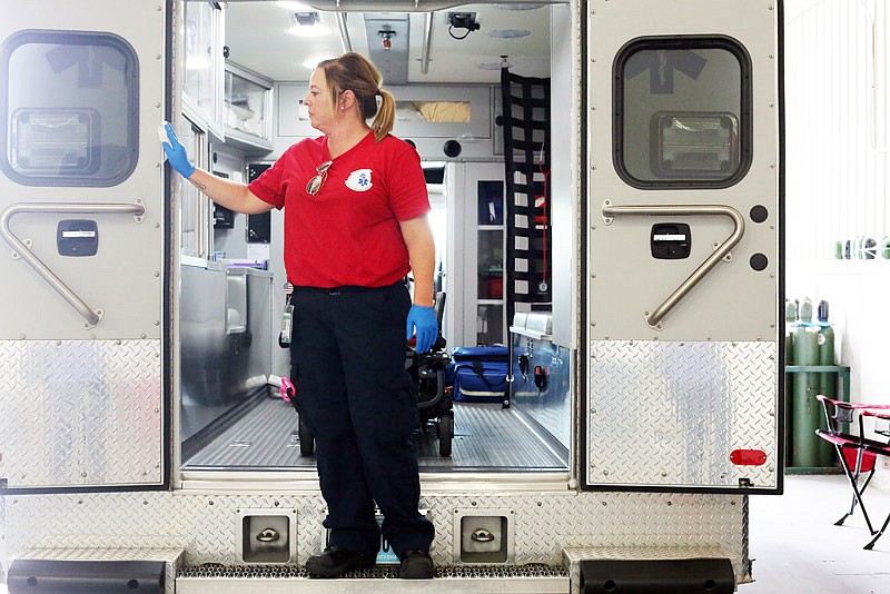 EMT Alison Peters wipes down an ambulance at the end of a shift at Cole County Emergency Medical Services in Jefferson City on Tuesday, July 18, 2017. Peters said response trucks are cleaned after every call and at the end of each shift.