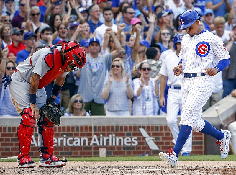 Chicago Cubs' Jon Jay, right, scores on a double hit by Ben Zobrist as St. Louis Cardinals catcher Yadier Molina, left, reacts during the eighth inning of a baseball game, Saturday, July 22, 2017, in Chicago. 