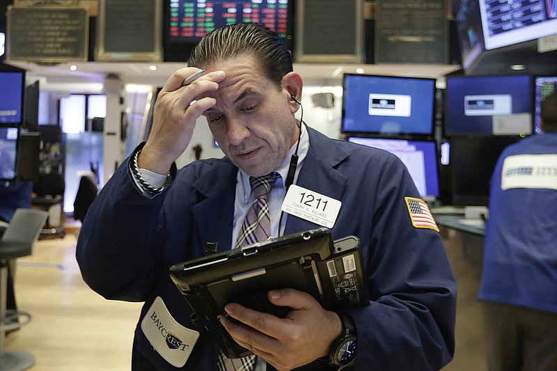 Trader Tommy Kalikas works on the floor of the New York Stock Exchange, Monday, July 24, 2017. Stocks are off to a mixed start on Wall Street as declines in health care and consumer-focused companies outweigh gains in other parts of the market. (AP Photo/Richard Drew)