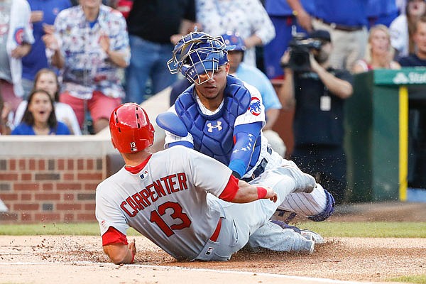 Cubs catcher Willson Contreras tags out Cardinals first baseman Matt Carpenter during the first inning of Sunday night's game at Wrigley Field in Chicago.