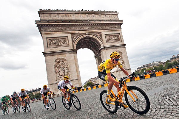 Chris Froome, wearing the overall leader's yellow jersey, passes the Arc de Triomphe during the 21st and final stage of the Tour de France on Sunday, covering 64 miles with a start in Montgeron, France and a finish in Paris.
