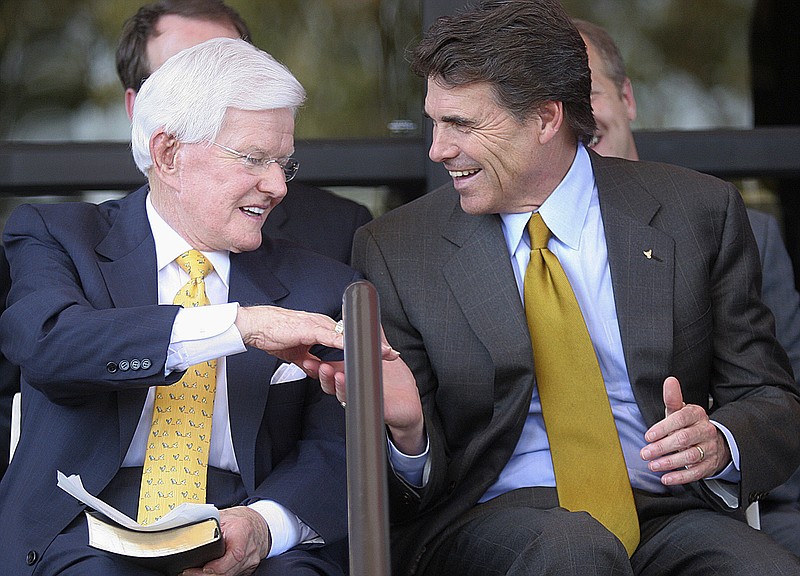 In this Sept. 18, 2005, photo, Lonnie "Bo" Pilgrim, CEO and chairman of the board of Pilgrim's Pride Chicken, left, shakes hands with Texas Gov. Rick Perry at the Dedication Open House of the companies new headquarters in Pittsburg, Texas. Pilgrim, who grew a one-time feed store into the world's largest poultry producer before losing the company in bankruptcy, has died at 89. A statement on the Erman Smith Funeral Home website says Pilgrim died Friday, July 21, 2017, at his Pittsburg home.