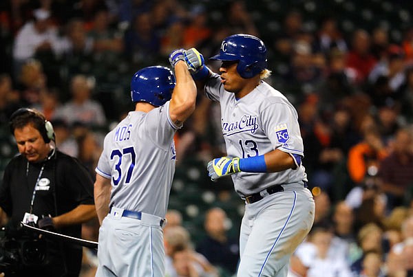 Royals catcher Salvador Perez celebrates with Brandon Moss after hitting a solo home run against the Tigers in the 12th inning of Monday night's game in Detroit.