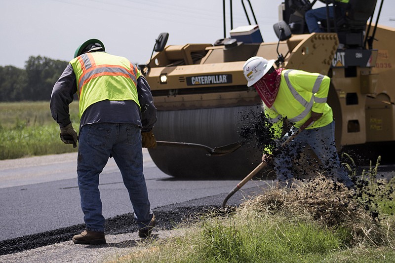 Crews with R.K. Hall Construction work on a repaving project Tuesday on U.S Highway 71 north of Texarkana on Tuesday. The project will cost $1.4 million and is expected to be completed in three months.
