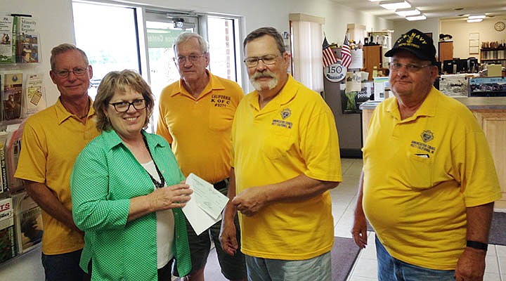 Members of the Annunciation Knights of Columbus #9271 present a check from the annual Tootsie Roll Drive to be used by the Moniteau County Association for Retarded Citizens (ARC) Camp Wonderland. Front row, from left, Barb Denker representing the Moniteau County ARC, accepts the check from Grand Knight Tim Baker as David Bax stands near. In the back row are Rudy Schroeder and J. David Gattermeir.