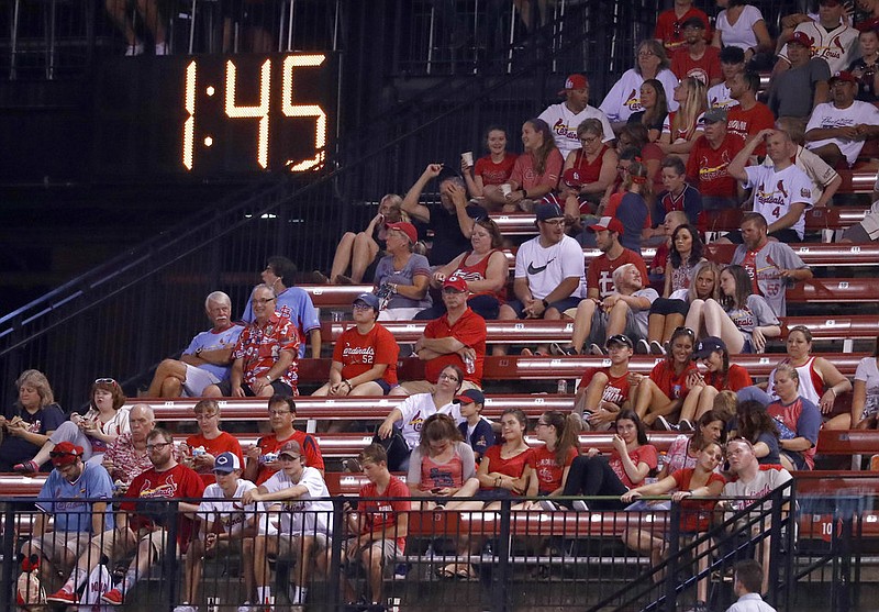A countdown clock in the outfield reads 1:45 at the end of the fifth inning of a baseball game between the St. Louis Cardinals and the Colorado Rockies on Tuesday, July 25, 2017, in St. Louis. Major League Baseball is experimenting with a shorter period between innings during the game with an eye on shortening games. 
