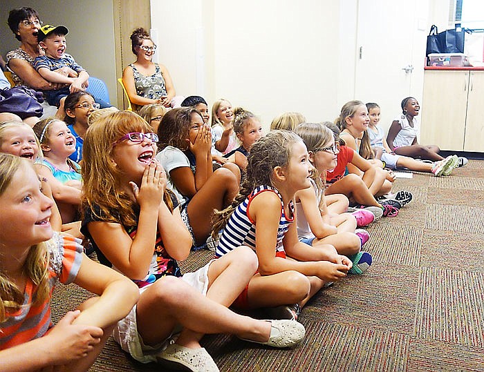 The crowd reacts to Pinocchio and Geppetto's antics during a two-man performance at the library on Wednesday.                                