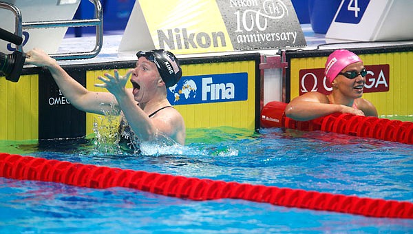 Lilly King celebrates after setting a new world record in the women's 100-meter breaststroke final as Russia's Yuliya Efimova looks on during Tuesday's World Aquatics Championships in Budapest, Hungary.