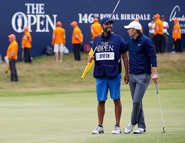 Jordan Spieth stands with his caddie Michael Greller on Sunday before putting on the 18th green at the British Open at Royal Birkdale in Southport, England.