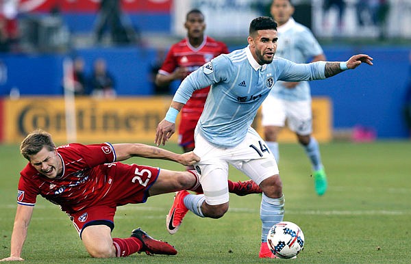 In this April 22 file photo, Sporting Kansas City forward Dom Dwyer takes control of the ball against FC Dallas defender Walker Zimmerman during a match in Frisco, Texas. Dwyer has been traded to Orlando City.