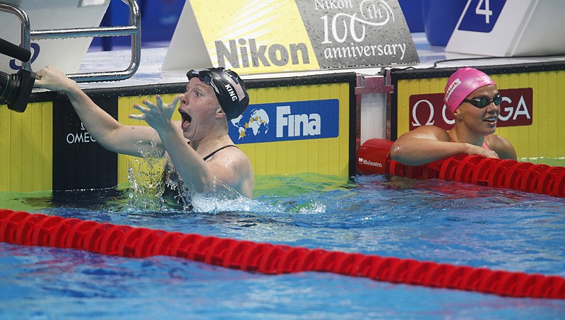 United States' Lilly King, left, celebrates Tuesday after setting a new world record in the women's 100-meter breaststroke final as Russia's Yuliya Efimova, right, looks on during the swimming competitions of the World Aquatics Championships in Budapest, Hungary. AP Photo/Darko Bandic