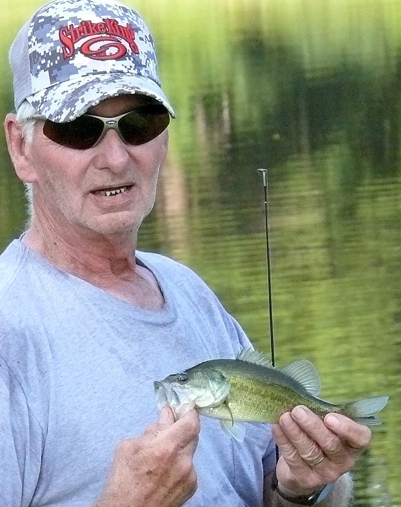 This little fellow is too small, R.K. Tilley said, so he'll throw the fish back in to be caught another day at Queen City Indepen-dent School District pond.
