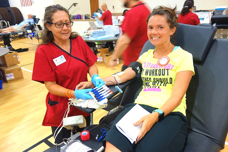 FILE: Katie Finley, right, relaxes as Carmen Trenco finishes drawing her blood during a 2017 drive.