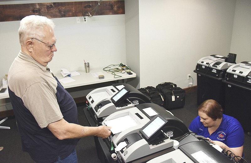 As is standard practice before elections within the county, officials from the Cole County Clerk's office, along with one member each of the Republican and Democrat parties, ran a test in July 2017 on four optical voting machines to be used in an Aug. 8 special election. Roy Beal is shown feeding test ballots into the machines while Karen Simpson retrieves the sample ballots.