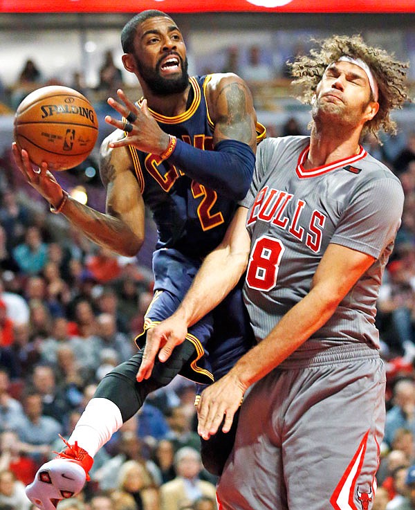 In this March 30 file photo, Cavaliers guard Kyrie Irving looks to pass against Bulls center Robin Lopez during a game in Chicago. Irving recently asked to be traded.