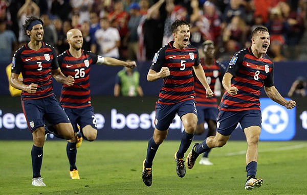 Jordan Morris (8) of the U.S. celebrates with teammates after scoring a goal against Jamaica during the second half of Wednesday night's Gold Cup final in Santa Clara, Calif.