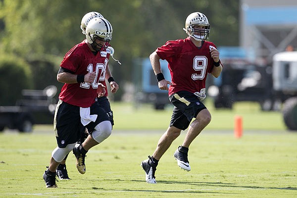 Saints quarterbacks Chase Daniel (10) and Drew Brees (9) run during training camp Thursday in Metairie, La.