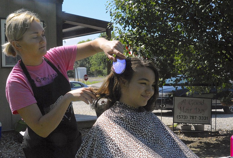 A Good Hair Day Family Salon in Clarksburg offered Haircuts for Charity Saturday, July 29, 2017 benefiting the Moniteau County Buddy Packs and celebrating the business' 10th anniversary. Megan Arnold, 12, received a trim from Drew Rubert.