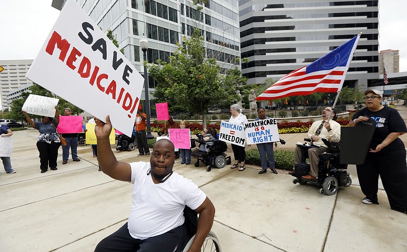 Mario Henderson leads chants of "save Medicaid," as other social service activists, Medicaid recipients and their supporters stage a protest outside the building that houses the offices of U.S. Sen. Thad Cochran, R-Miss., Thursday, June 29, 2017, in Jackson, Miss. Soaring prices and fewer choices may greet customers when they return to the Affordable Care Act's insurance marketplaces in the fall of 2017, in part because insurers are facing deep uncertainty about whether the Trump administration will continue to make key subsidy payments and enforce other parts of the existing law that help control prices. 