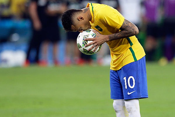 In this Aug. 20, 2016 file photo, Brazil's Neymar kisses the ball before scoring the decisive penalty kick during the final of the men's Olympic soccer tournament in Rio de Janeiro, Brazil.