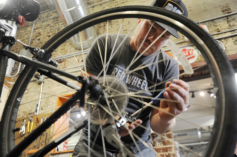 Nick Smith repairs a bike last week at Red Wheel Bike Shop. Jefferson City is setting up a bicycle subcommittee in order to apply for a bicycle-friendly designation.