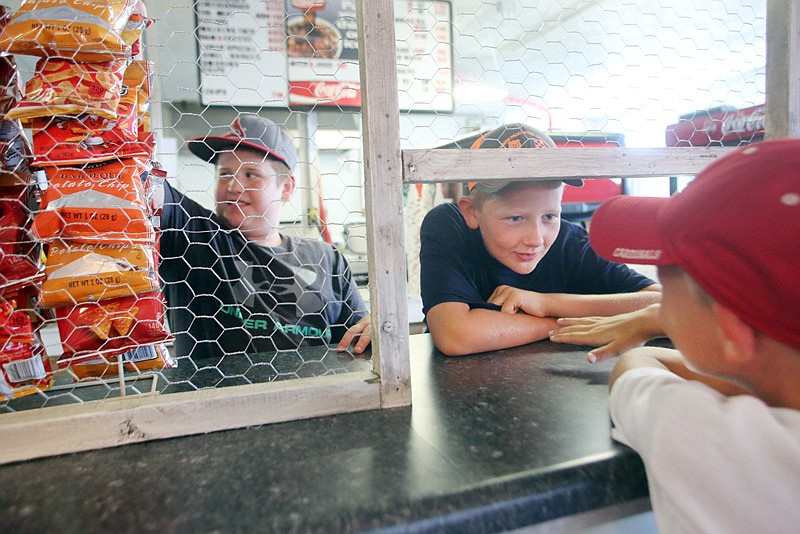 From left, Gavin Roe, Garrett Holtgrewe and Grant Holtgrewe practice working behind the 4-H food stand Saturday, July 29, 2017 at the Jaycee Fairgrounds in preparation for the county fair that kicks off Monday evening. The stand recently received new countertops donated by Jeff Hoelscher, Cole County Eastern District Commissioner.