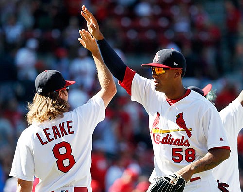 Cardinals teammates Mike Leake and Jose Martinez celebrate following Sunday afternoon's 3-2 win against the Diamondbacks at Busch Stadium.