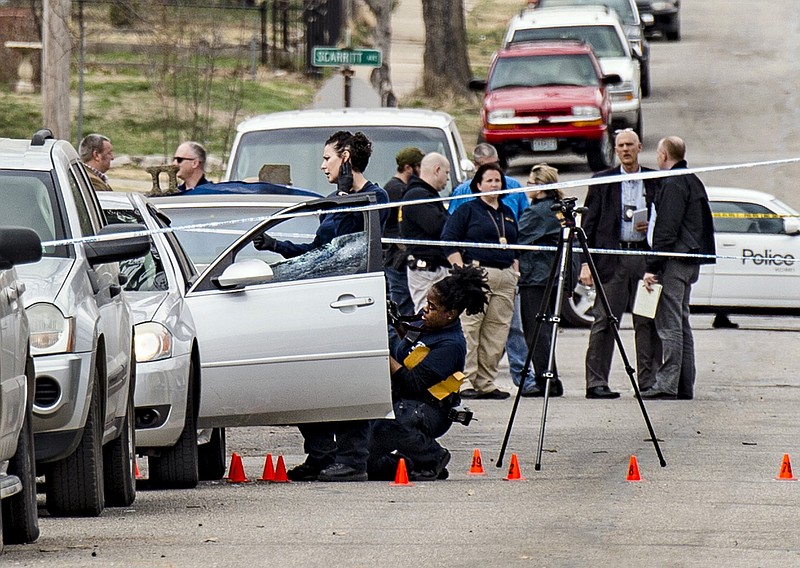 In a March 6, 2017 photo, Kansas City Police investigate a double shooting in the 100 block of North Drury Avenue in the Kansas City's northeast side that left one man dead. The city’s 86 homicides as of Monday, July 31, 2017, are 26 more than the same period in 2016 _ a year that ended with 130 murders, the most here since 1998.   (Allison Long/The Kansas City Star via AP)