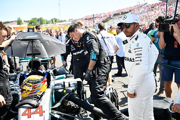 Lewis Hamilton waits while his car is prepared Sunday for the Formula One Hungarian Grand Prix.