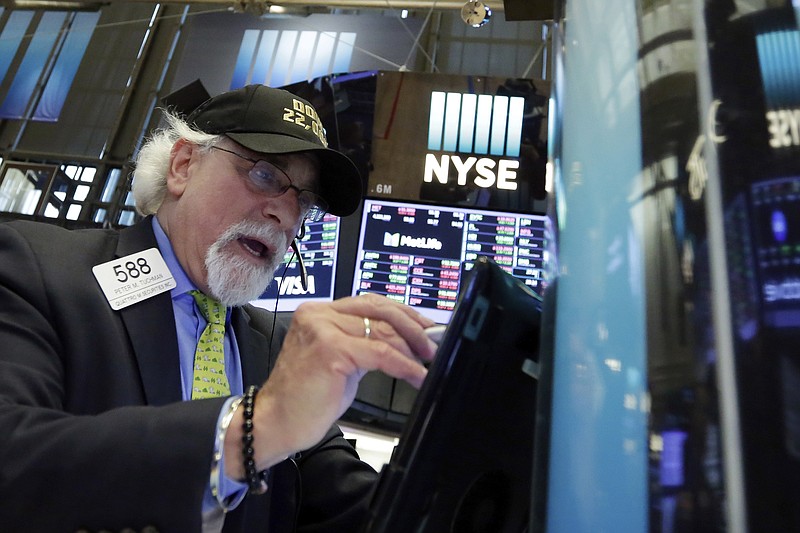 Trader Peter Tuchman wears a "Dow 22,000" hat as he works on the floor of the New York Stock Exchange, Wednesday, Aug. 2, 2017. The Dow Jones industrial average closed above 22,000 points for the first time, driven by a big gain in Apple on an otherwise mixed day for the market. (AP Photo/Richard Drew)