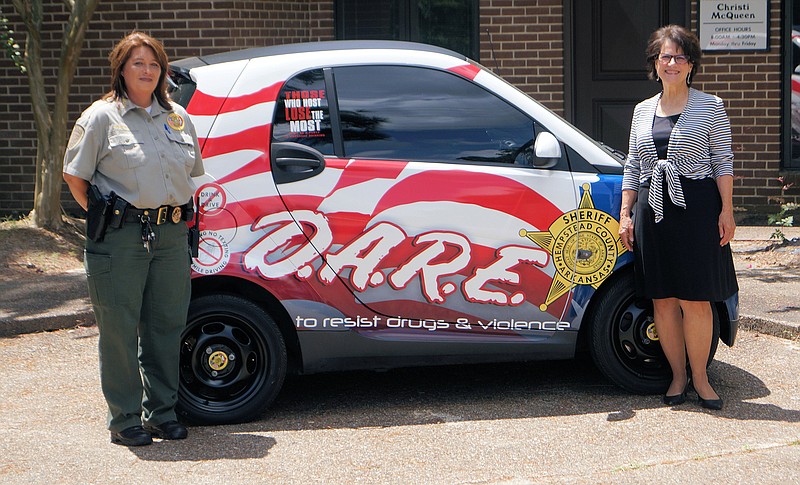 The Hempstead County Sheriff's Office recently purchased a used Smart car for its D.A.R.E. program. The vehicle was bought with seized funds from Prosecuting Attorney Christi McQueen, Sheriff James Singleton said. The Smart car will be used by the Hempstead D.A.R.E officer as she travels to schools throughout the county to teach the 10-week program. It will replace a 2006 Jeep Commander donated by Hope Auto in 2011. "I would like to thank Prosecutor McQueen for this piece of equipment and being a dedicated prosecutor that has always supported my office in our efforts to educate our children on the danger of drugs, alcohol and abuse," Singleton said. Pictured are Hempstead County D.A.R.E. Officer Deputy Marla Barnhill, left, and McQueen.