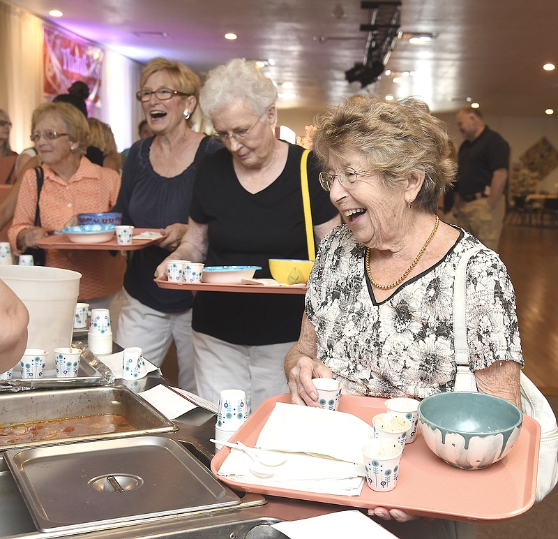 Rita Bonnot, right, is all smiles while asking for a sample of soup as she and Alice Bonnot, Pat Wall and Ruth Schnieders go through the line at Tuesday's second annual Empty Bowls fundraiser at Windstone Entertainment to benefit the Salvation Army. All the soup, desserts and bread was donated so proceeds go to the local Salvation Army. Leading up to the event, anyone could decorate a bowl to be set out for those attending to take with them.