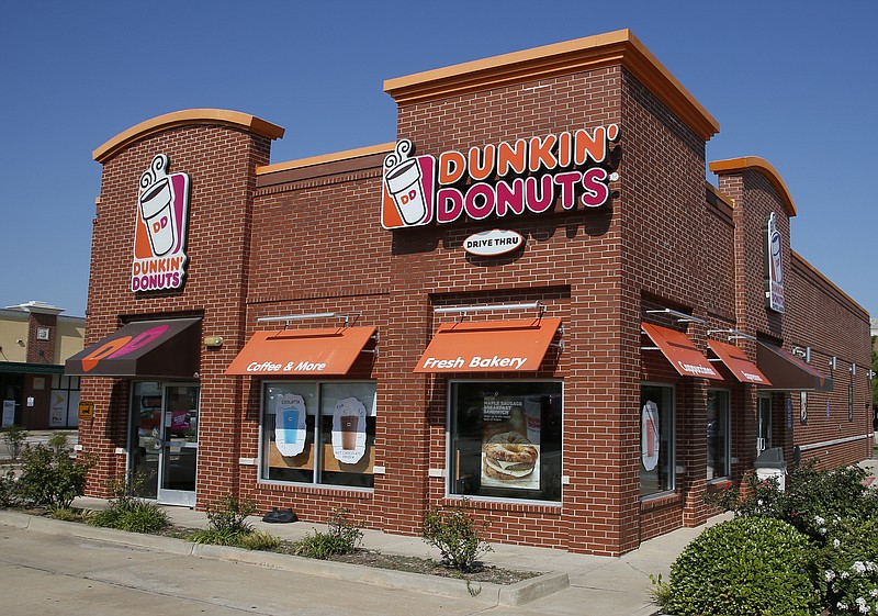 FILE - This Thursday, July 28, 2016, file photo shows a Dunkin' Donuts in Edmond, Okla. Dunkin' is thinking about dumping "Donuts" from its name. A new location in Pasadena, Calif., will be called simply Dunkin', a move that parent company Dunkin' Brands Inc. calls a test. The Canton, Mass.-based company says a few other stores will get the one-name treatment too. (AP Photo/Sue Ogrocki, File)