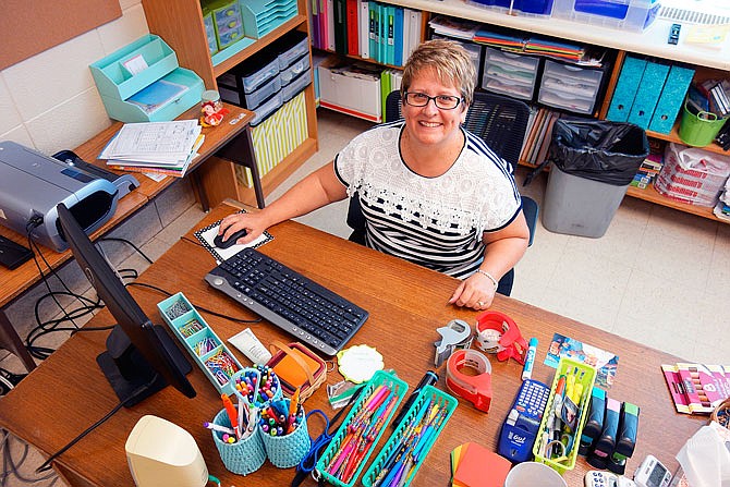 New Bloomfield Elementary School teacher Kathy Howell prepares her desk for the Aug. 17 start of school.