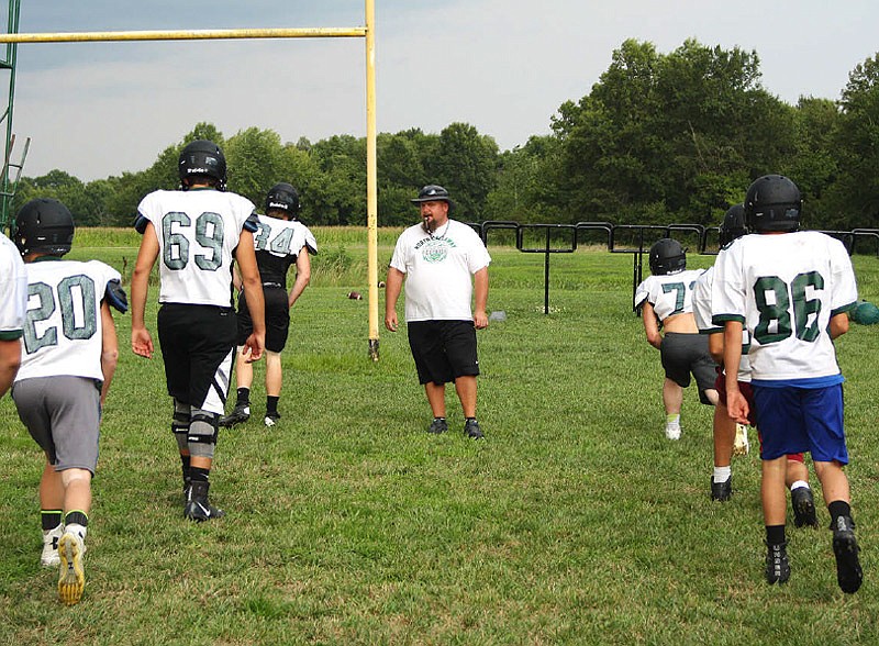 North Callaway head football coach Kevin O'Neal guides the Thunderbirds through warmup drills before the start of practice Wednesday night, Aug. 2, 2017 at the high school. North Callaway starts the 2017 season at home against Southern Boone on Friday, Aug. 18.