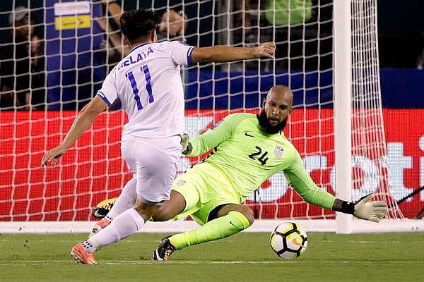 United States goalie Tim Howard blocks a shot by El Salvador's Rodolfo Zelaya during a CONCACAF Gold Cup quarterfinal match last month in Philadelphia. Howard returned to Major League Soccer last year after 13 years in the English Premier League.